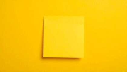 Bright yellow sticky note on a yellow background
