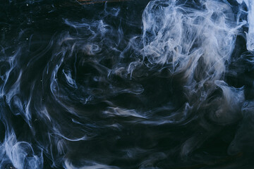 Abstract colorful smoke background. Moving flow of dark blue paints, fluid art
