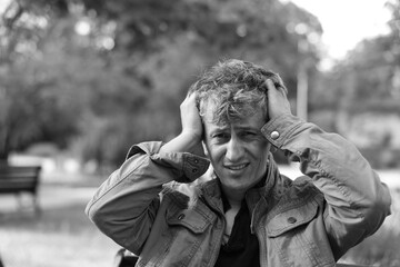 Portrait of homeless man outdoors. Black and white effect