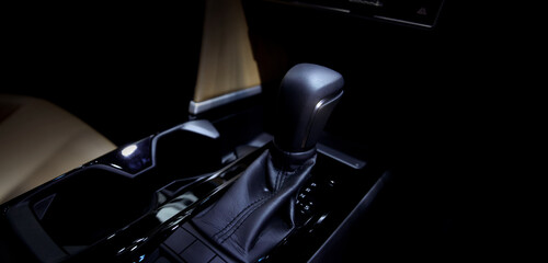 EV Car gear. Close up of modern automatic car gear shifters in luxury vehicle interiors. Feature...