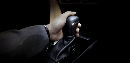 EV Car gear. Close up of modern automatic car gear shifters in luxury vehicle interiors. Feature...