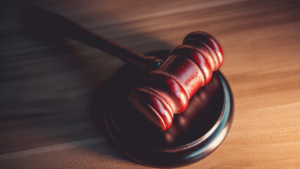 Judge’s gavel on wooden table, symbolizing judgment, law, fairness, and legal authority in court...