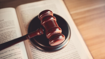Judge’s gavel on wooden table, symbolizing judgment, law, fairness, and legal authority in court...