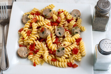 rotini pasta  served with tomatoes and chicken sausage