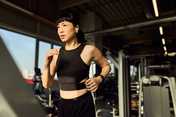 Woman Running on a Treadmill Indoors Focused on Fitness and Health
