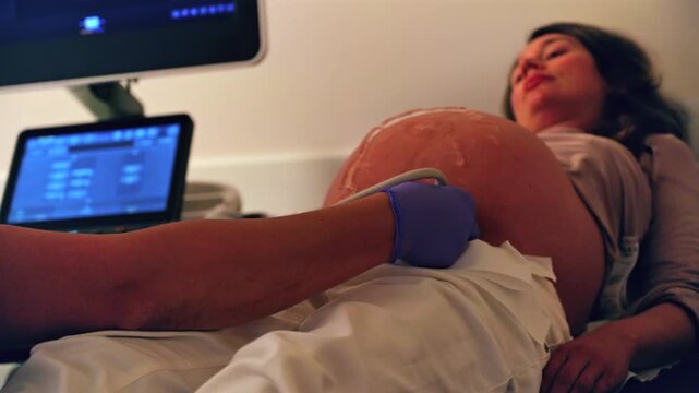 Pregnant woman undergoing an ultrasonography at a doctor's office