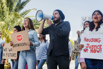 Group of Hispanic people activists protesting against gentrification and high housing costs in Mexico City, women and men marching on streets for human rights and Housing crisis in Latin America