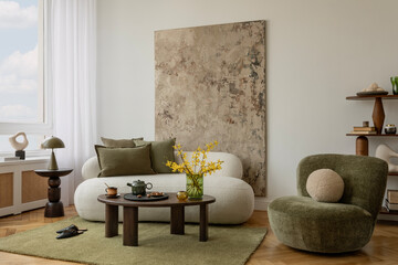 Elegant interior corner with olive armchair, stylish lamp, art work on the wall and warm natural light. Soft and modern. © FollowTheFlow