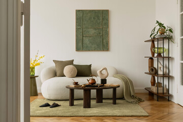 Modern interior with graphic mock up wall art, sculptural decorations, bouclé sofa and green...