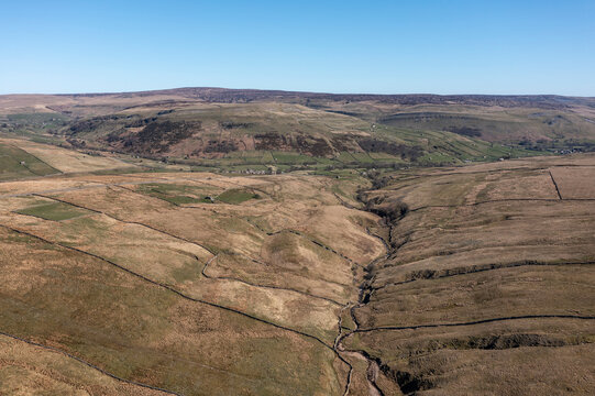 north side of the buttertubs pass in swaledale in the yorkshire dales north yorkshire england looking along the cliff beck towards muker and thwaite elevated view blue sky no people