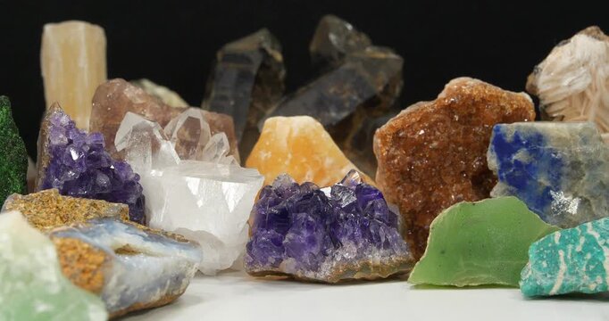 Natural Semi Precious stones and minerals, riches of Earth. Green garnet, purple Amethysts, Quartz crystals, blue Lazurite, green Nephrite and Amazon stone, yellow Citrine, Barite and golden Pyrite