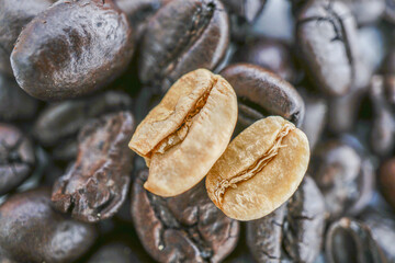 Close up image of roasted and unroasted coffee beans showcases their contrasting textures and...