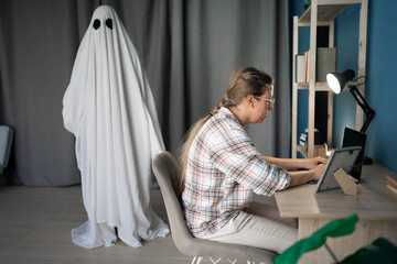 Concept of afterlife and memory for lost love. Sad depressed woman working at home while male ghost...