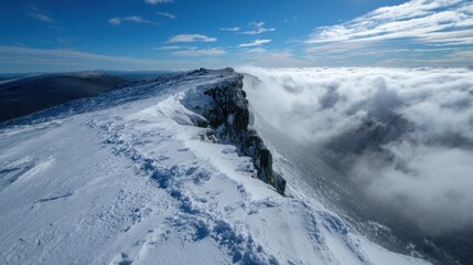 Snowy mountain ridge, clouds below