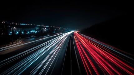 Long exposure captures vibrant car light trails on a highway at night, creating motion