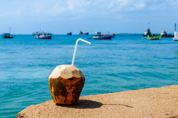 Coconut juice with blue water a background