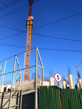 Construction site with crane under clear blue sky