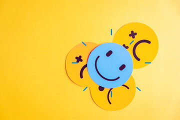 Emotional state and mental wellness. Smiley face by multiple sad expressions showing mood variation and contrast. Useful for psychology, emotion tracking, and mental health themes.