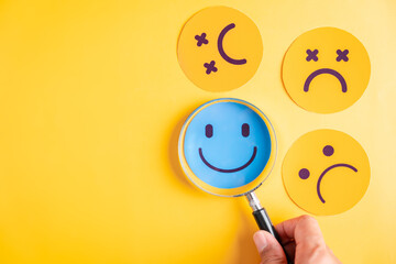 Focus on happiness, magnifying glass smiley face among sad feeling. Great for mental health, emotional well being, positivity, therapy, and motivation.