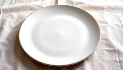 An empty white plate, ready for a delicious meal, sits on a textured surface, inviting anticipation. The plate's simplicity provides an elegant base for culinary creation.