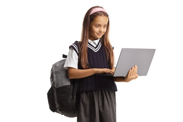 Girl in a school uniform holding a laptop computer and looking at the screen