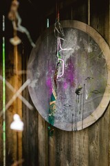 Mystical Round Wall Art with Eye Motifs and Abstract Elements, Rustic Wood Backdrop, Unique Decor.