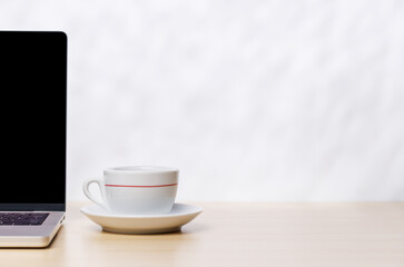 Laptop and cup of coffee on a empty copy space
