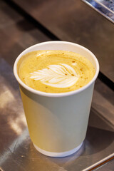 Warm cappuccino in a cup with latte art on top