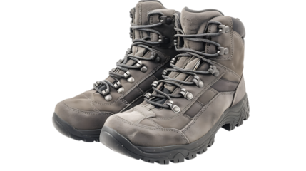 A pair of gray leather hiking boots with laces and metal eyelets on a plain studio surface