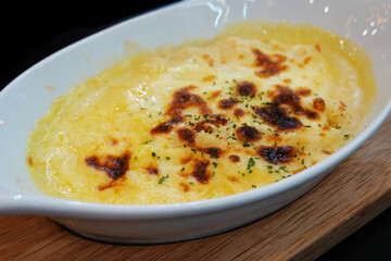 Creamy mashed potatoes baked with cheese on top.
