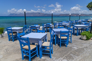 Seaside Greek Taverna with Blue Chairs and Sea View, Crete, Greece