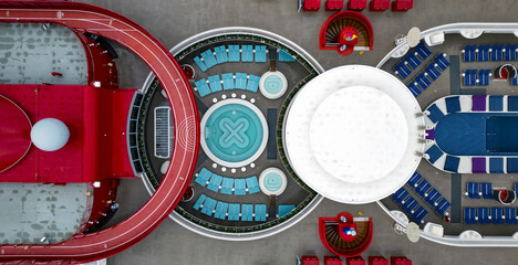 Aerial view of a vibrant and geometric deck with a red running track, turquoise loungers, and a central white platform creating a modern, playful vista, Split, Split-Dalmatia County, Croatia.