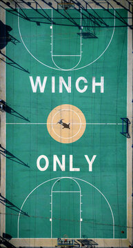 Aerial view of a vibrant green basketball court with white lines and the words 'WINCH ONLY' in bold letters, Split, Split-Dalmatia County, Croatia.