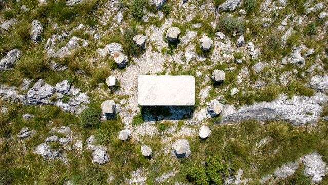 Aerial view of a rectangular stone monument encircled by smaller pillars amidst the rugged terrain, Split, Split-Dalmatia County, Croatia.