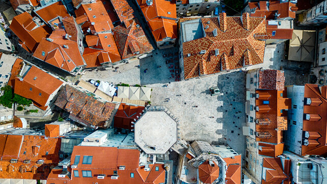 Aerial view of terracotta rooftops casting warm shadows over the ancient stone streets leading to the Peristyle courtyard, Split, Split-Dalmatia County, Croatia.