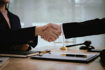 A lawyer consulting with a client in an office, reviewing legal documents and contracts related to justice, law, and business.	