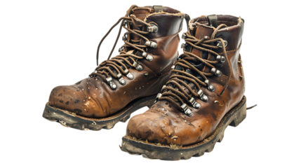 A pair of worn leather hiking boots with metal eyelets and tied laces on a transparent surface