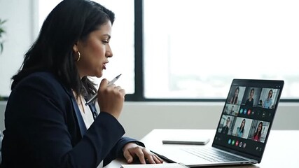Woman in a suit at a video conference on her laptop - Powered by Adobe