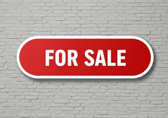 Obraz premium Prominent red oval sign clearly displaying the words for sale against a textured brick wall