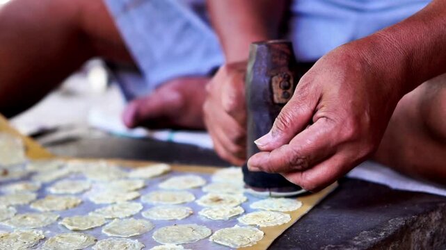 The process of making emping melinjo (melinjo chips). It tastes a little bitter and very tasty. Melinjo is also known as Gnetum gnemon