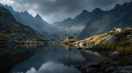 Mountain landscape with cloudy skies reflecting on tranquil lake in the early morning