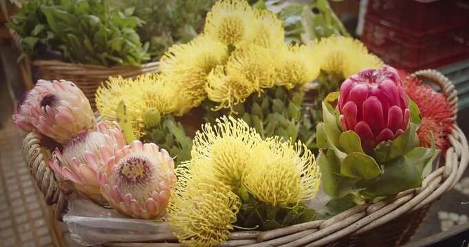 Exotic flowers in a basket at Lavradores Market, Madeira, showcasing local floral beauty