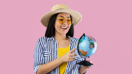 Dream Vacation. Portrait of excited happy asian woman traveller holding geographic globe, wearing...