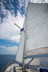 Sailing yacht moving at full speed with all sails up in the open sea near Croatia. Dynamic maritime adventure and freedom of ocean travel.