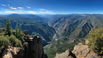 Fototapeta premium High-angle panoramic view of a river cutting through a mountain valley