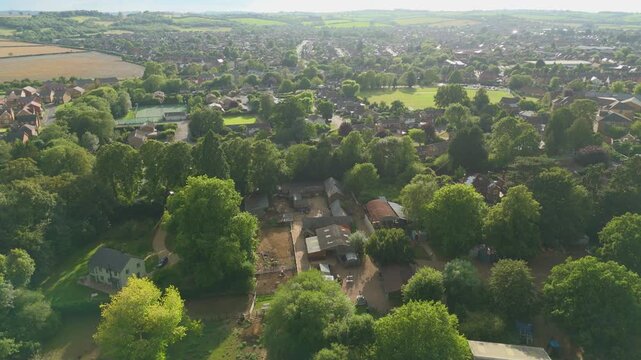 Aerial drone view of small English town, Oakham, England, late evening sunset in summer. Historic market town surrounded by lush green landscape
