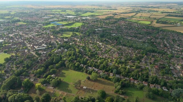 Aerial drone view of small English town, Oakham, England, late evening sunset in summer. Historic market town surrounded by lush green landscape