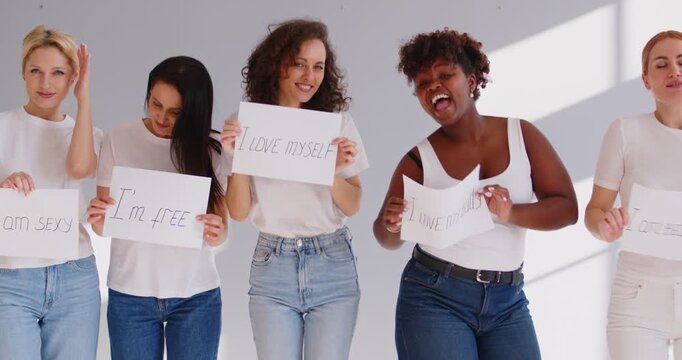 Happy positive diverse girls posing with motivating quotes and inspiring statements, best friends gather, successful women advertising, group of women celebrating hen party, hangout, lady confidence