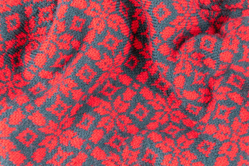 knitted christmas background in red and green with stars and leaves