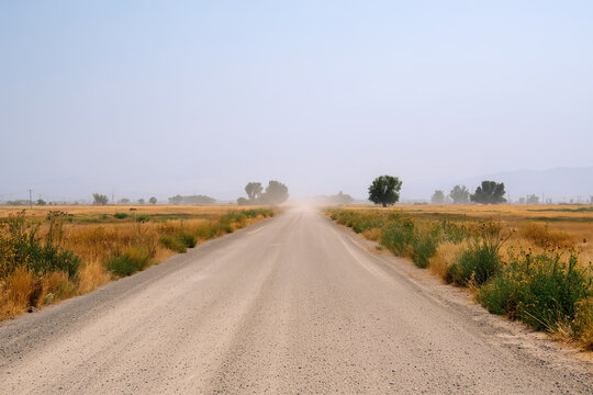 Hot and dusty empty dirt road in the countryside